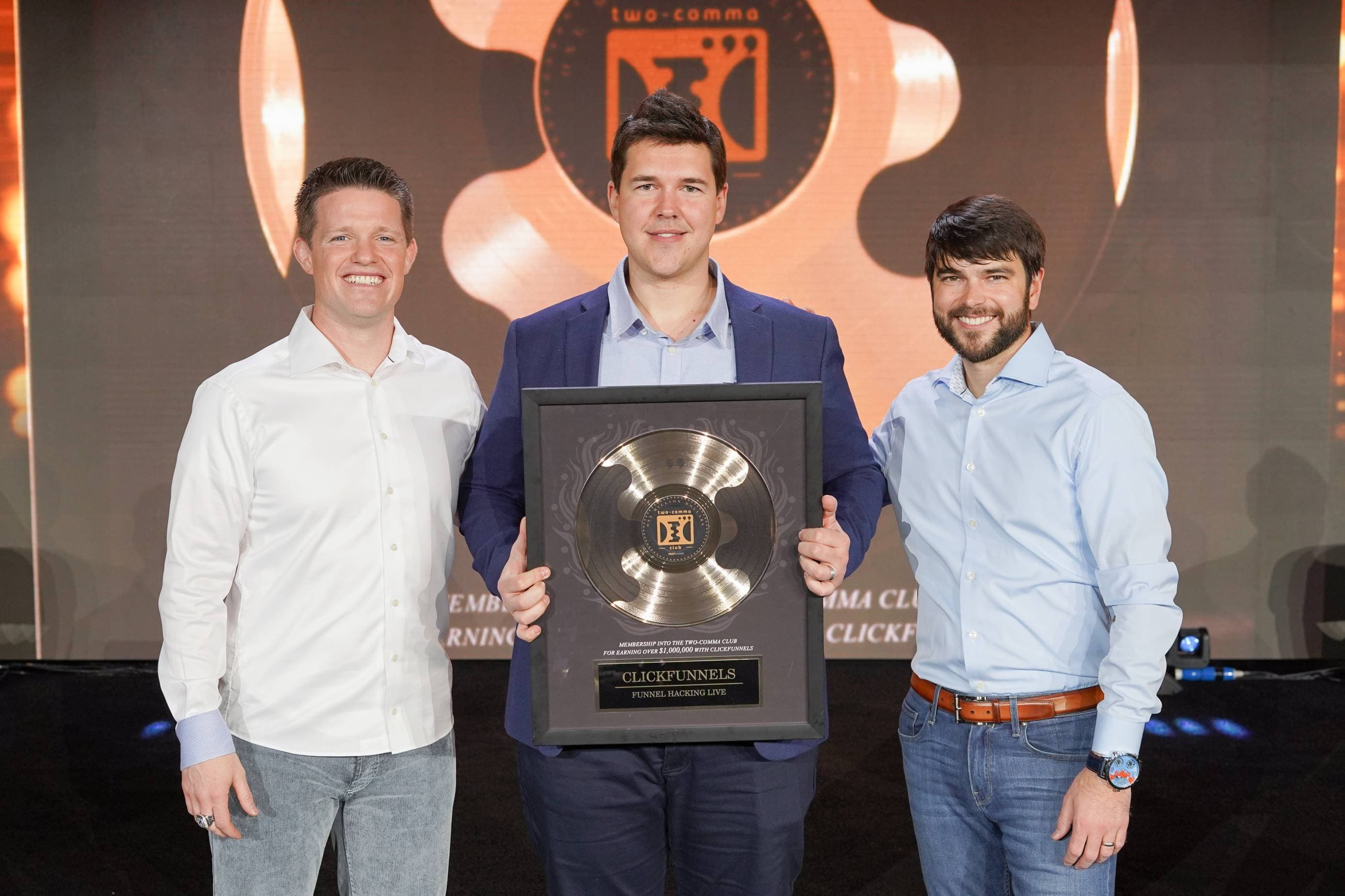 Justin Ingram receiving the ClickFunnels 2 Comma Club award on stage